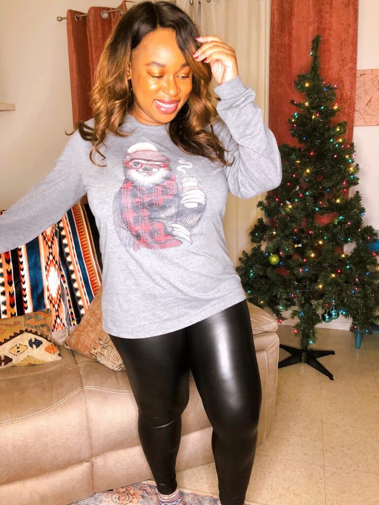 faux leather leggings with a christmas themed long-sleeved graphic tee