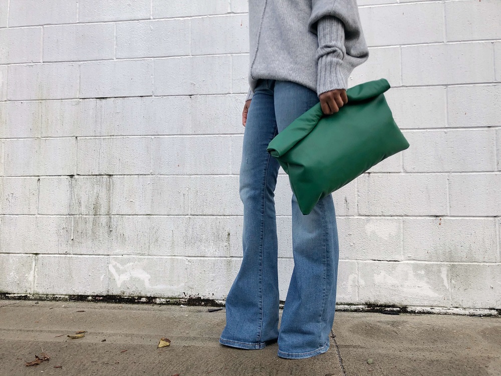 black owned business holiday guide feature: green rolled leather clutch from love, cortnie