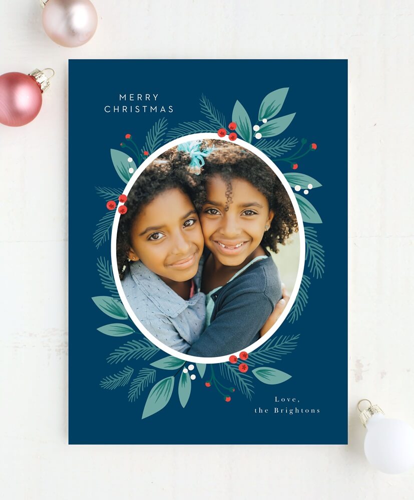 blue christmas photo card with cute picture of young twin sisters smiling at the camera 