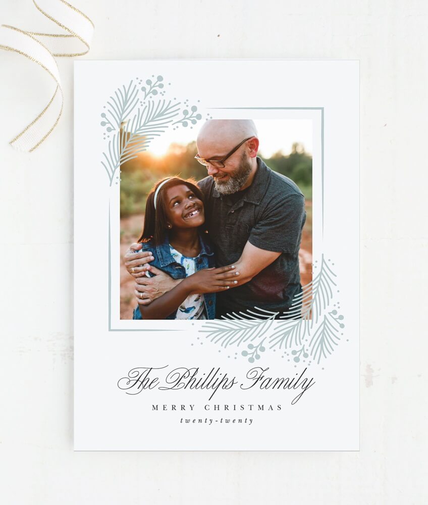 simple minimalist christmas photo greeting card with image of father and daughter embracing and smiling 