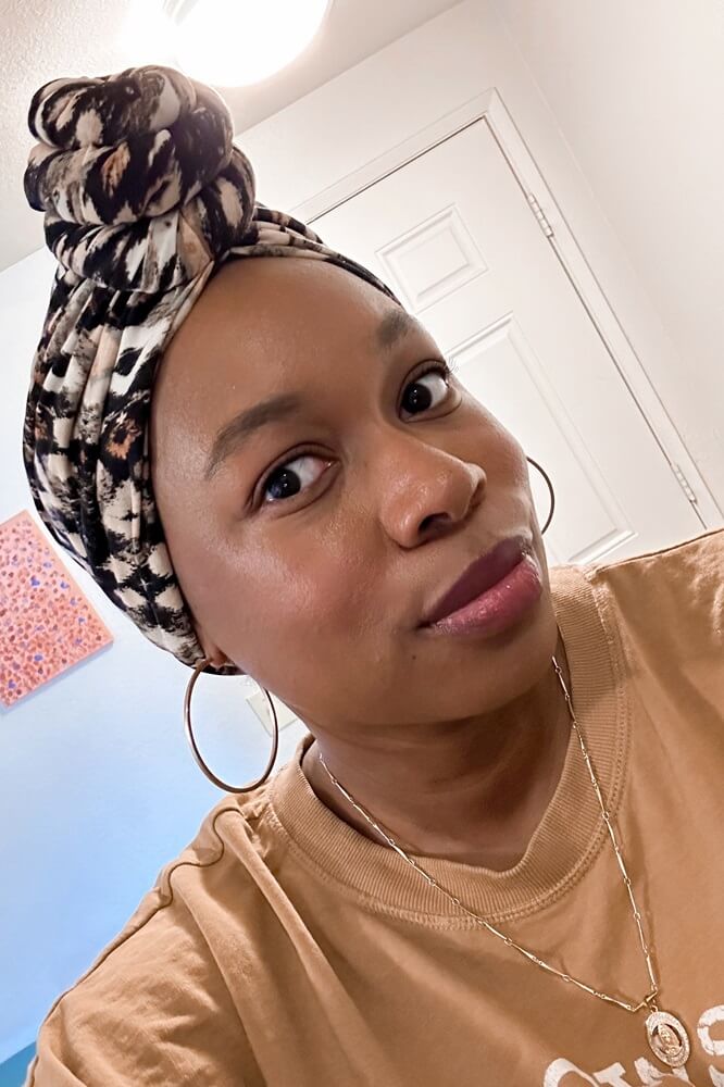 african american woman wearing a black and taupe turban style headwrap