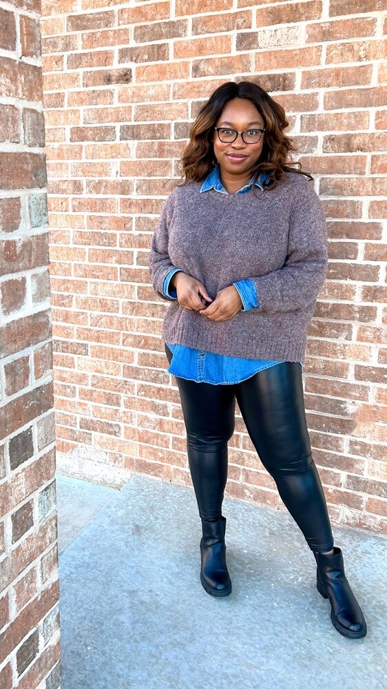 easy to create leather leggings outfit featuring a brown sweater, layered over a denim to with black boots 